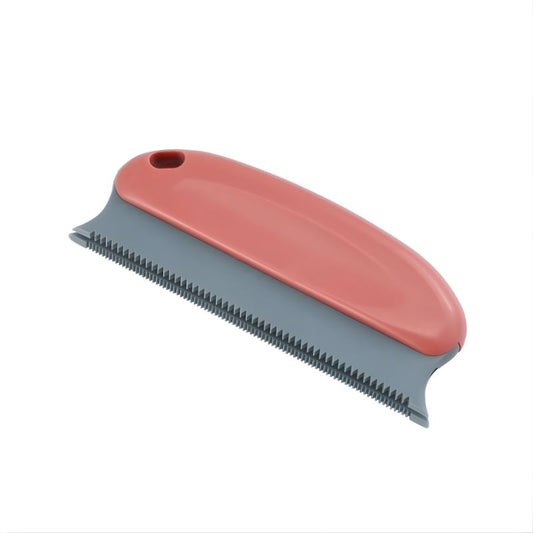 Pet grooming brush with red handle and gray bristle side on a white background