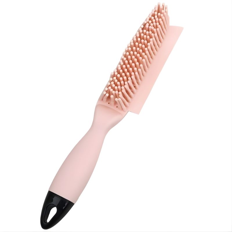 Pink brush with a black handle on a white background
